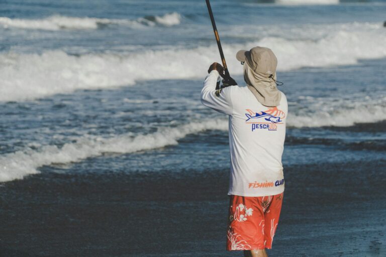 Fisherman casting rod on Altata beach in sunny weather, capturing the essence of coastal leisure.